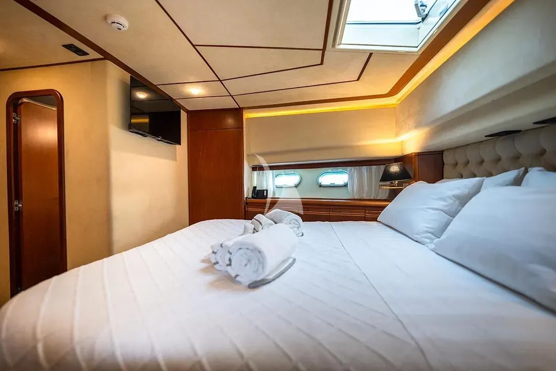 a bed with white sheets aboard BELLAS BOY Yacht for Sale