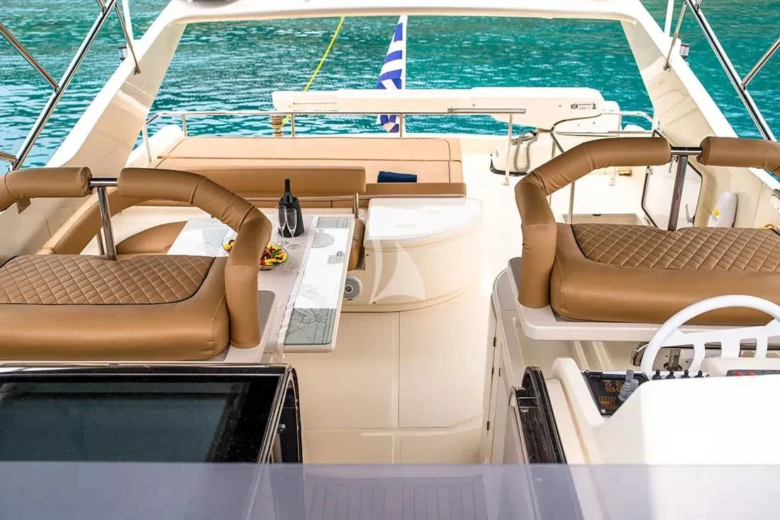 a boat with a chair and a table on it aboard BELLAS BOY Yacht for Sale