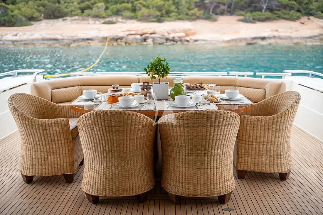 a table set for a meal on a beach aboard BELLAS BOY Yacht for Sale