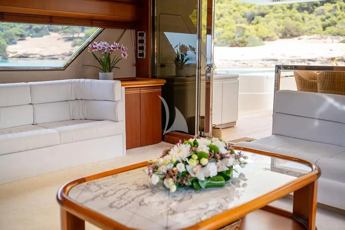 a table with flowers on it aboard BELLAS BOY Yacht for Sale