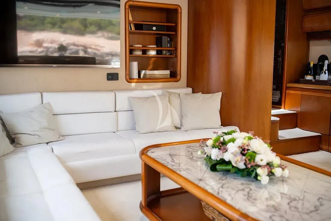 a living room with a white couch and a table aboard BELLAS BOY Yacht for Sale