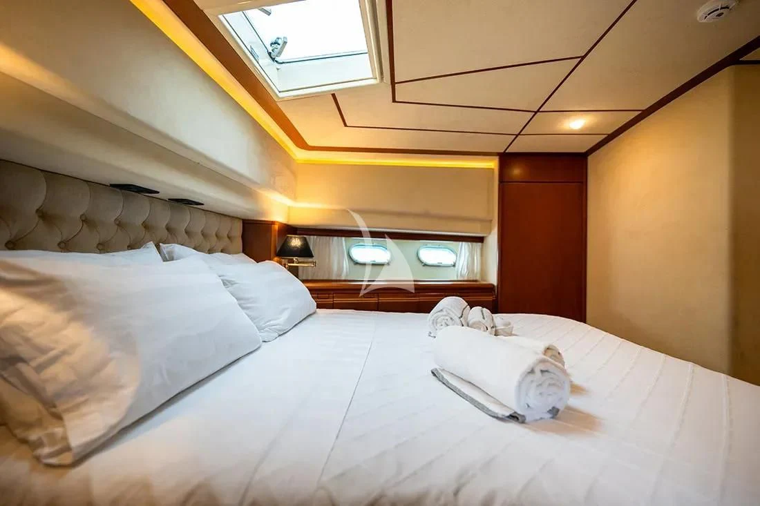 a bed with a white sheet and pillows on it aboard BELLAS BOY Yacht for Sale