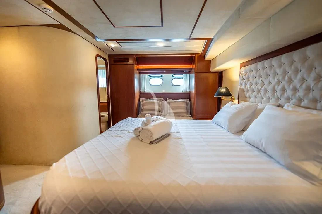 a bed with a white bed spread aboard BELLAS BOY Yacht for Sale