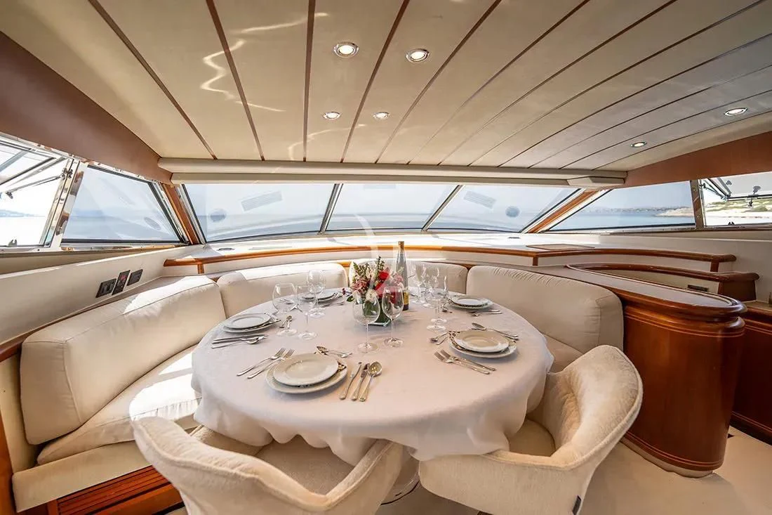 a dining table in a train aboard BELLAS BOY Yacht for Sale
