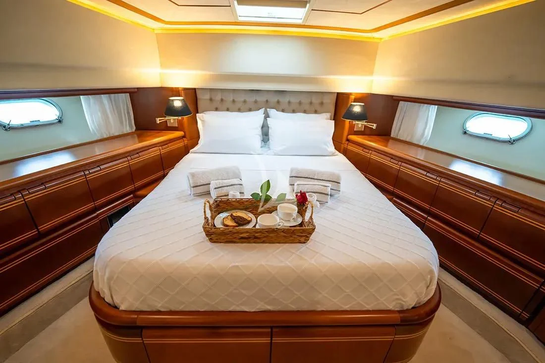 a bed with white sheets and pillows aboard BELLAS BOY Yacht for Sale