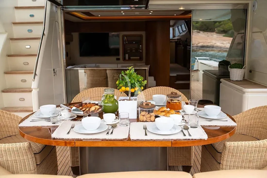 a table with food and drinks aboard BELLAS BOY Yacht for Sale