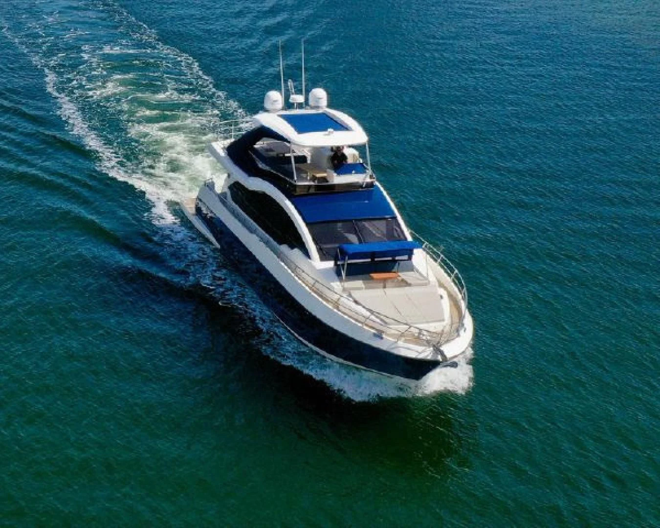 a large ship in the water aboard THE ONLY BLUE 66 FLY Yacht for Sale