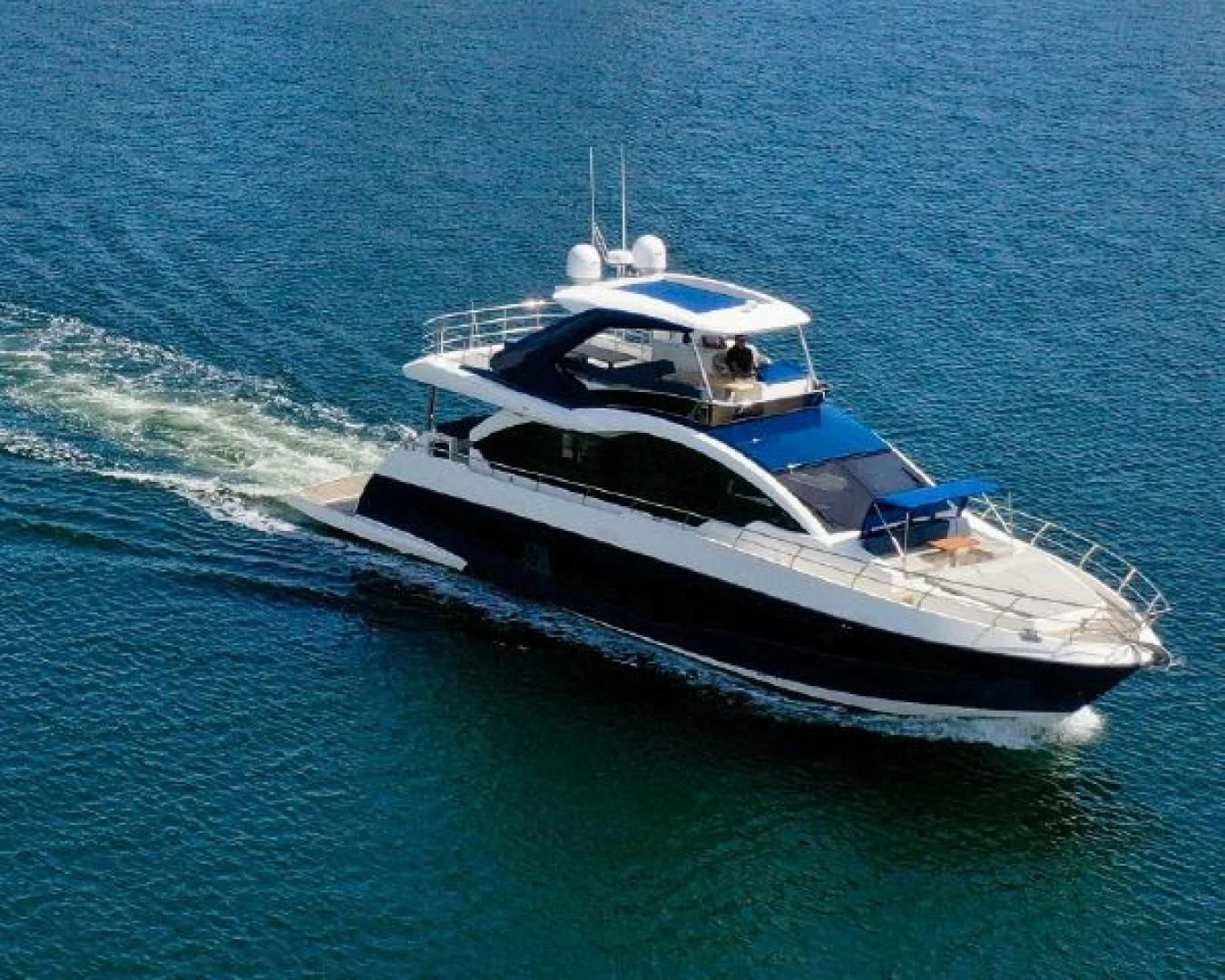 a white boat on the water aboard THE ONLY BLUE 66 FLY Yacht for Sale