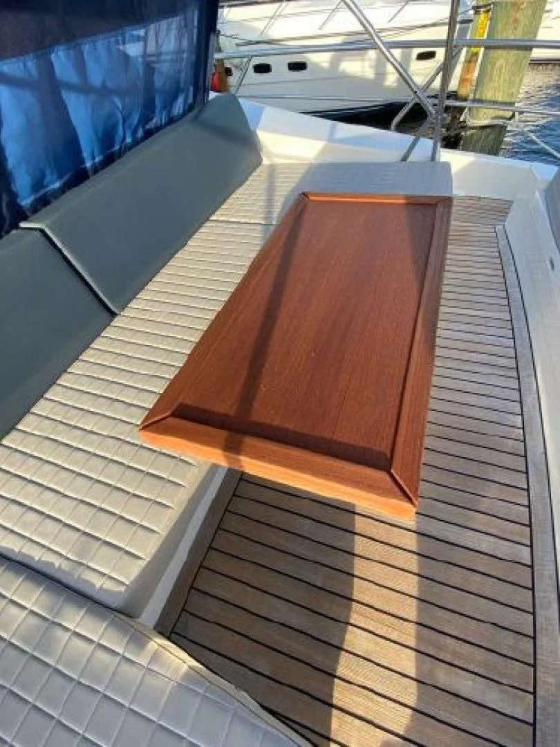 a wooden deck with a railing aboard THE ONLY BLUE 66 FLY Yacht for Sale