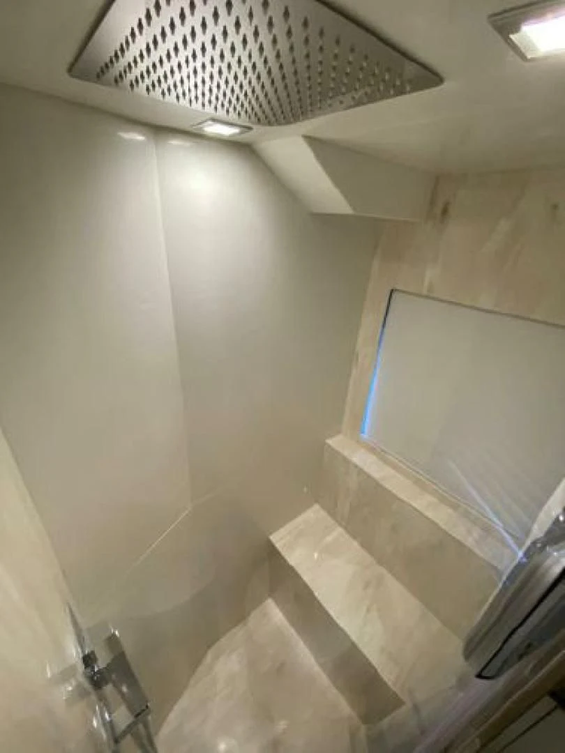 a room with a fan and a window aboard THE ONLY BLUE 66 FLY Yacht for Sale
