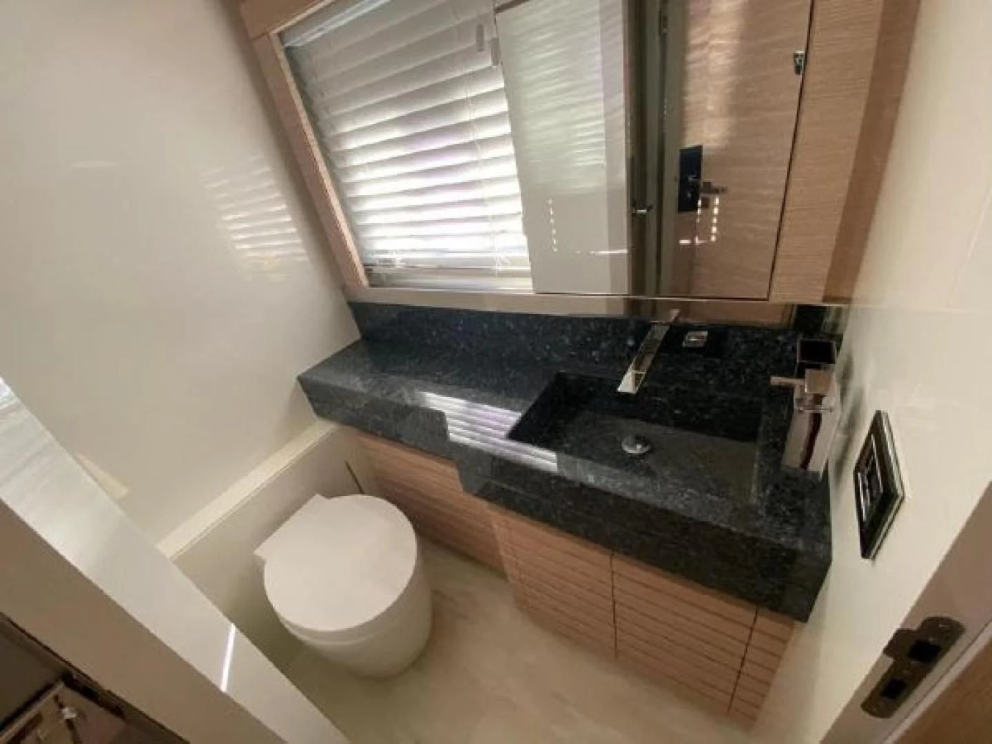 a bathroom with a marble counter top aboard THE ONLY BLUE 66 FLY Yacht for Sale