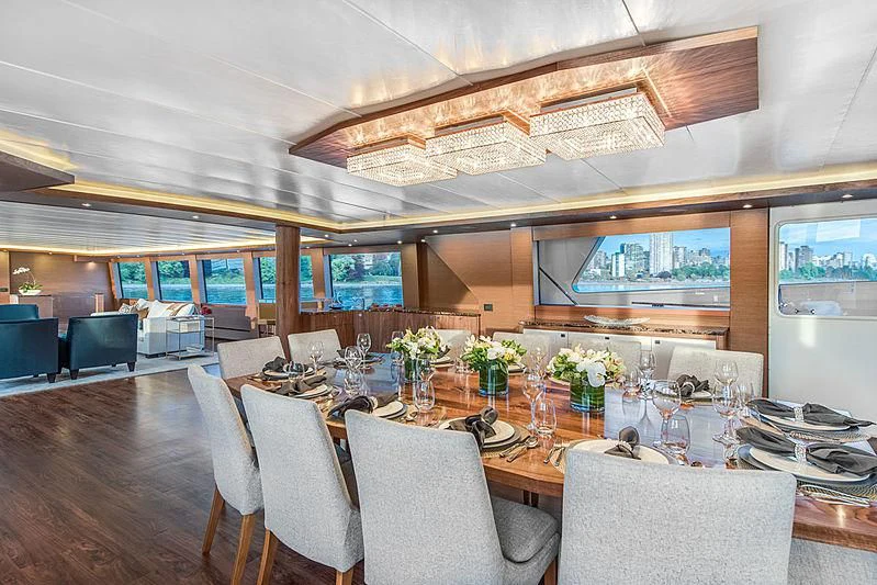 a room with a table chairs and flowers on the floor aboard ASCENTE Yacht for Charter