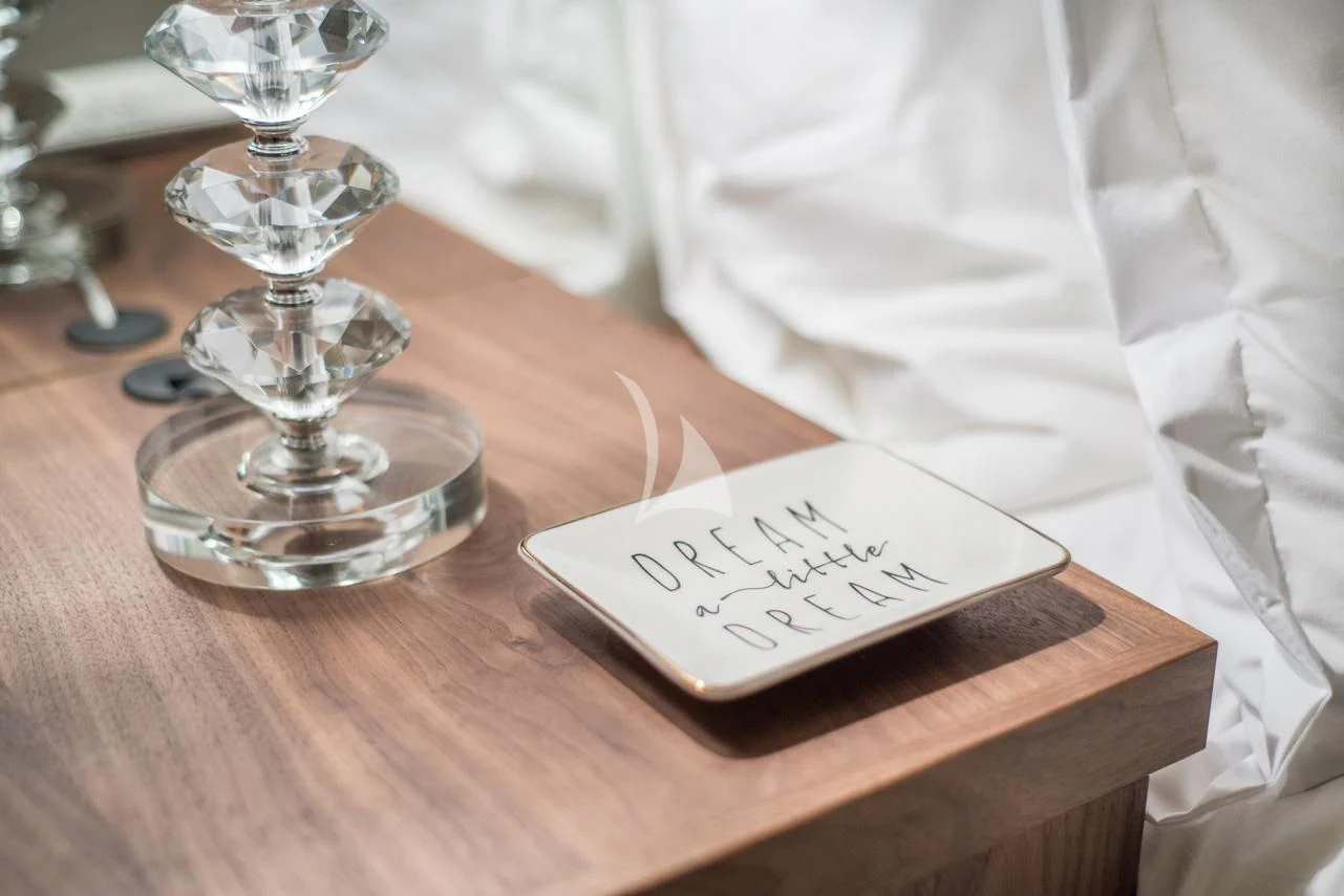 a glass of wine and a book on a table aboard ASCENTE Yacht for Charter