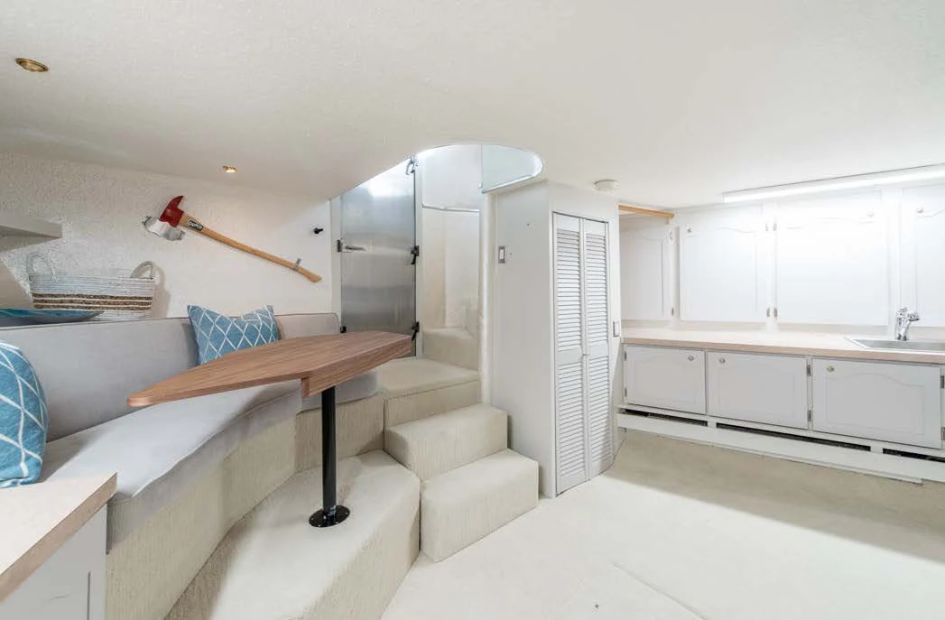 a room with a bed and a table aboard ASCENTE Yacht for Charter