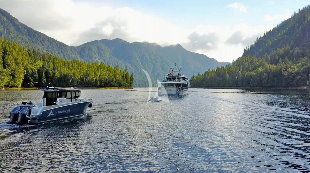 a couple of boats on a lake aboard ASCENTE Yacht for Charter