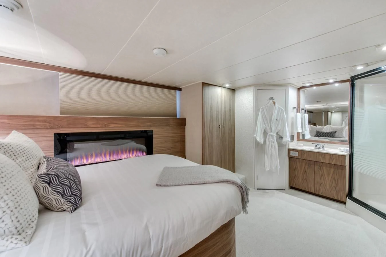 a bedroom with a bed and a mirror aboard ASCENTE Yacht for Charter