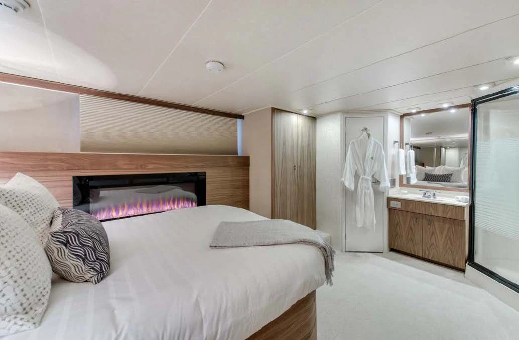 a bedroom with a bed and a mirror aboard ASCENTE Yacht for Charter