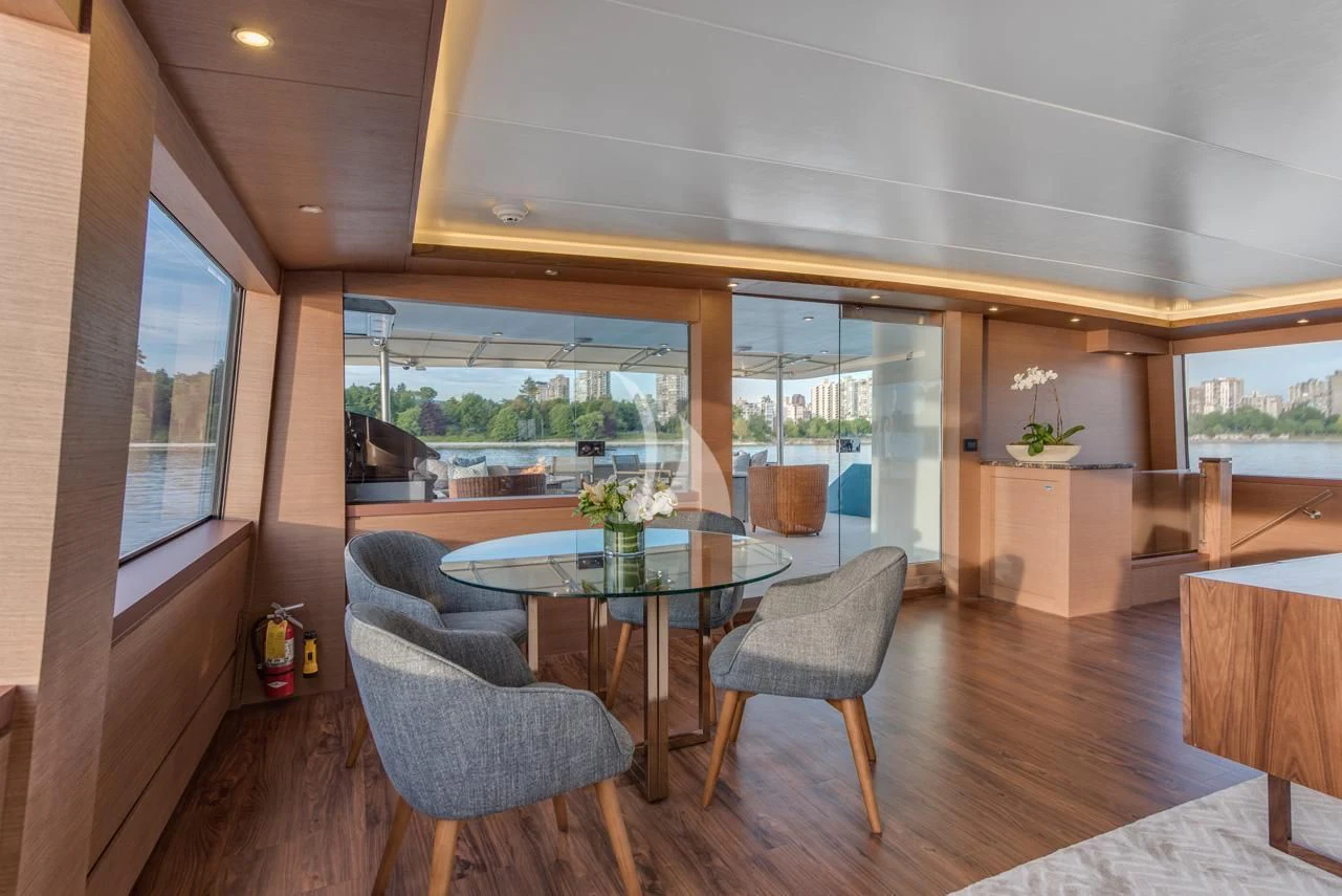 a room with a table chairs and a window aboard ASCENTE Yacht for Charter