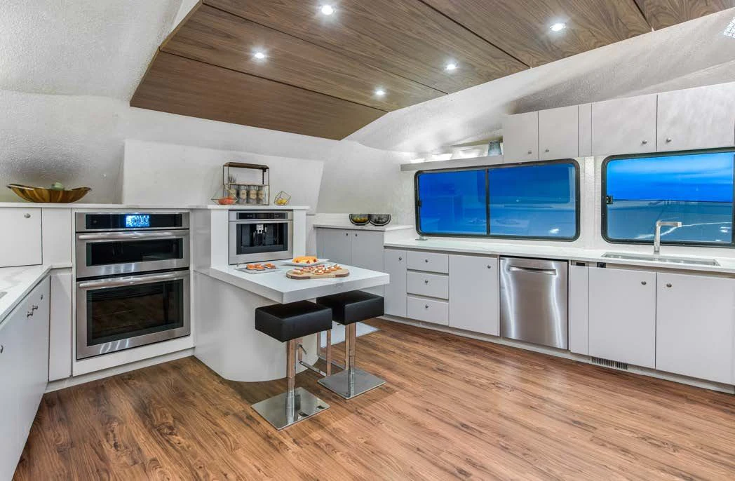 a kitchen with white cabinets aboard ASCENTE Yacht for Charter