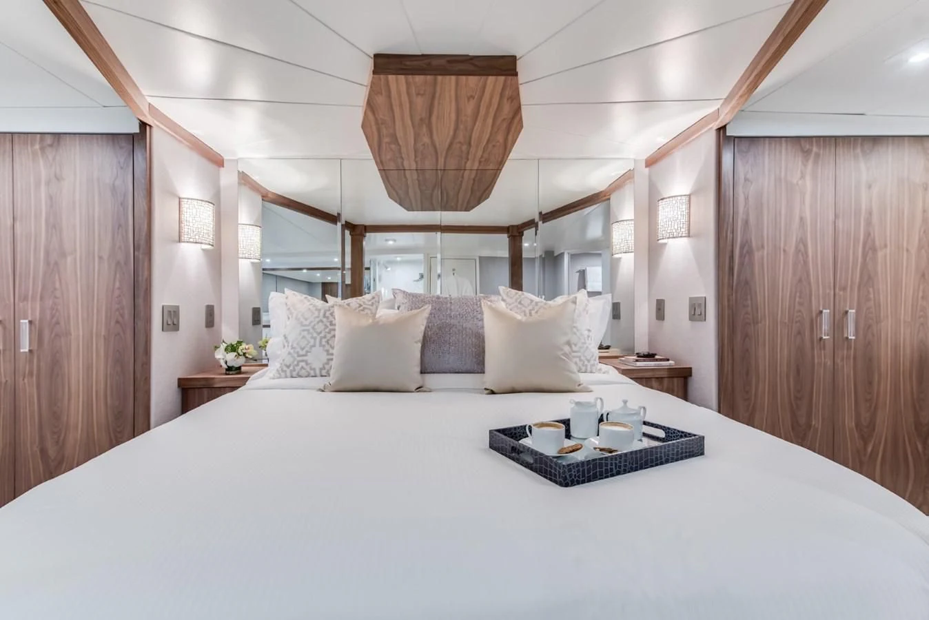 a bed with white sheets and pillows aboard ASCENTE Yacht for Charter
