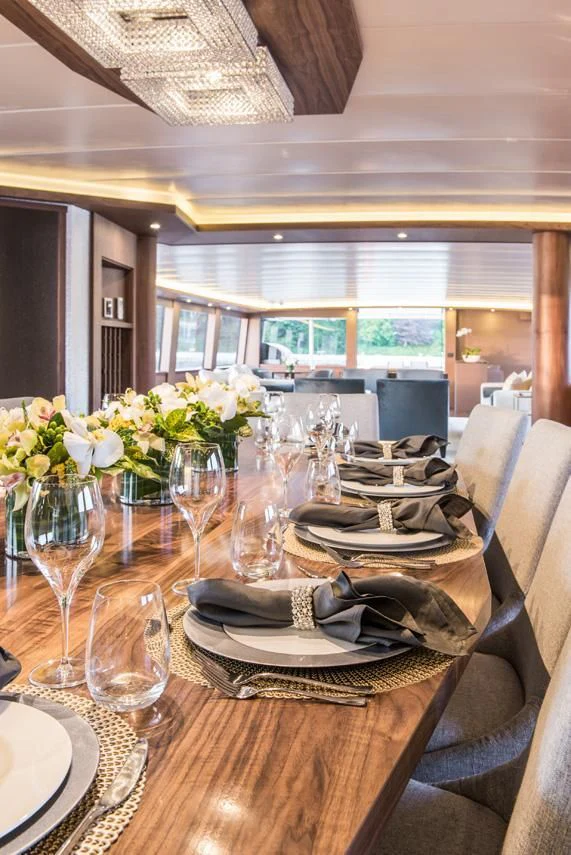 a table with plates and glasses aboard ASCENTE Yacht for Charter