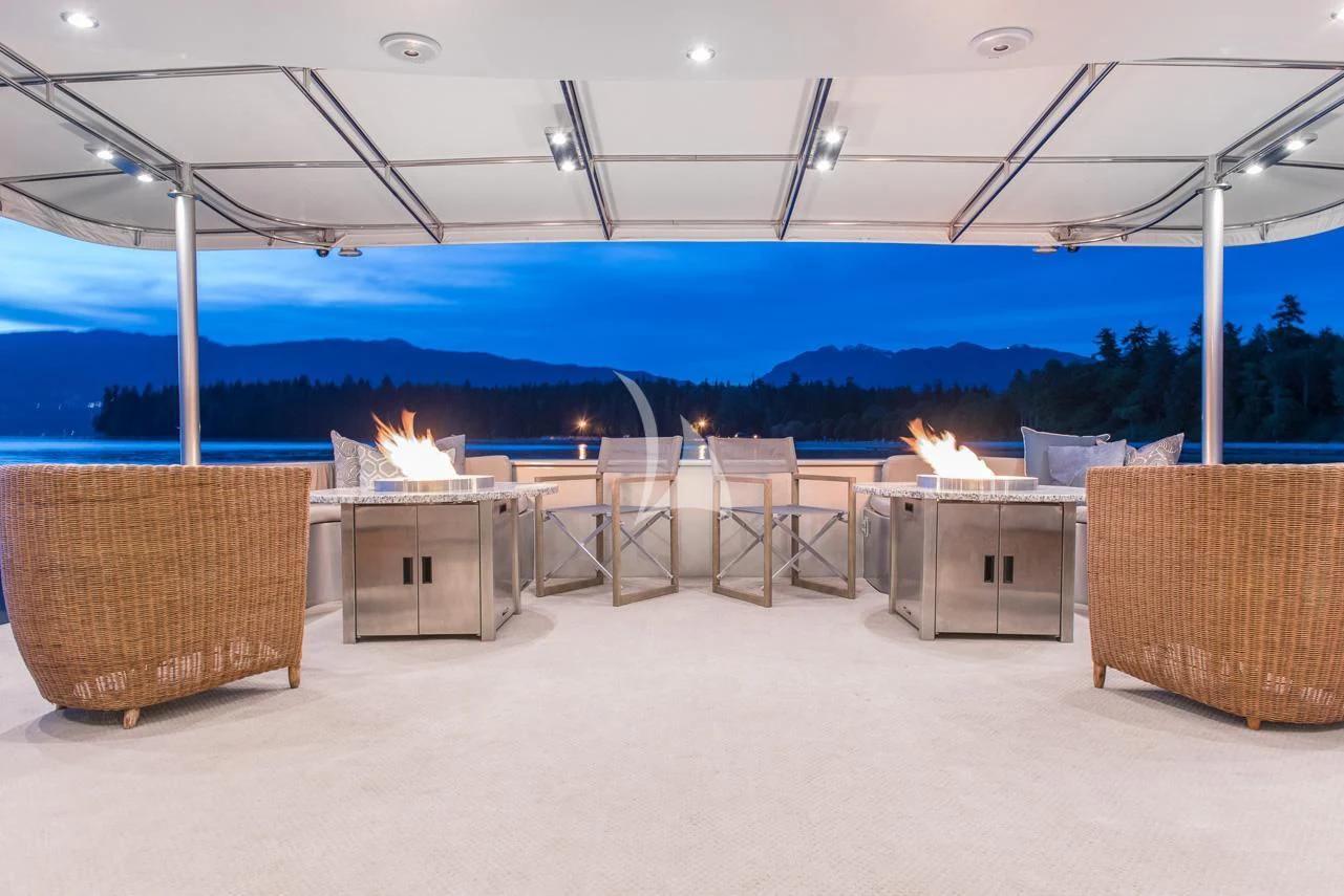 a large fire pit with a fire pit and chairs aboard ASCENTE Yacht for Charter