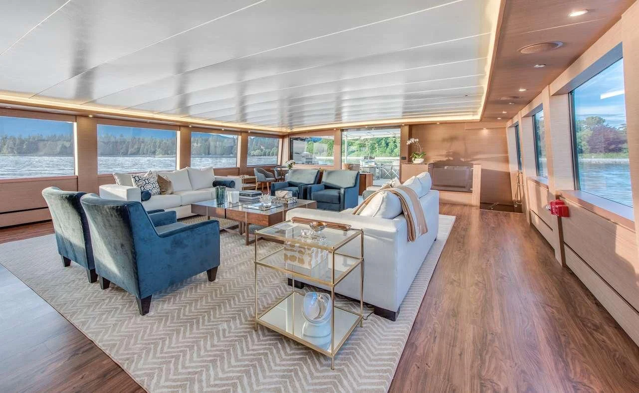 a living room with a large window aboard ASCENTE Yacht for Charter