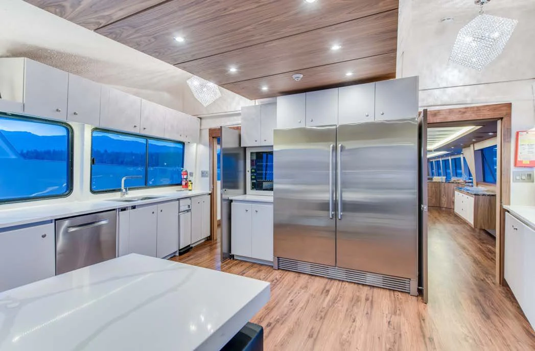 a kitchen with a large refrigerator aboard ASCENTE Yacht for Charter