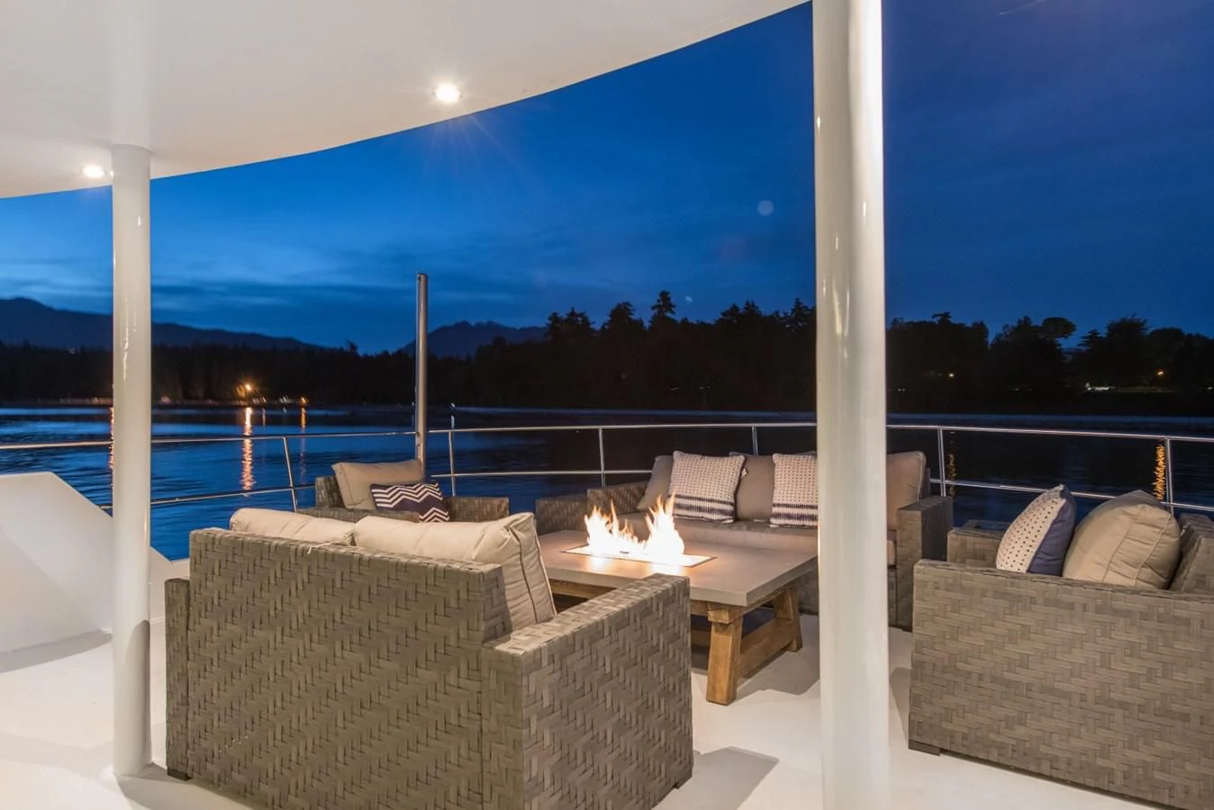 a large white lounge chair on a balcony overlooking a body of water aboard ASCENTE Yacht for Charter