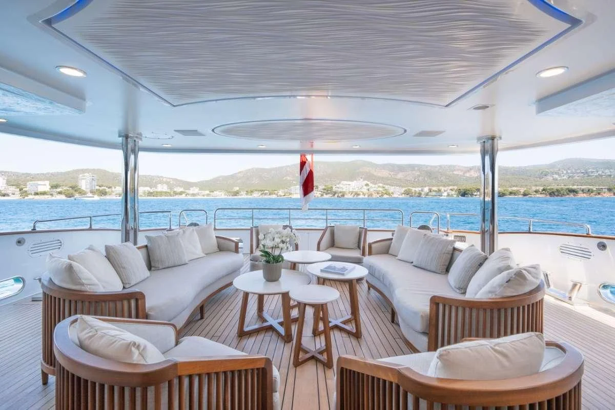 a room with couches and tables aboard TITIAN PEARL Yacht for Sale