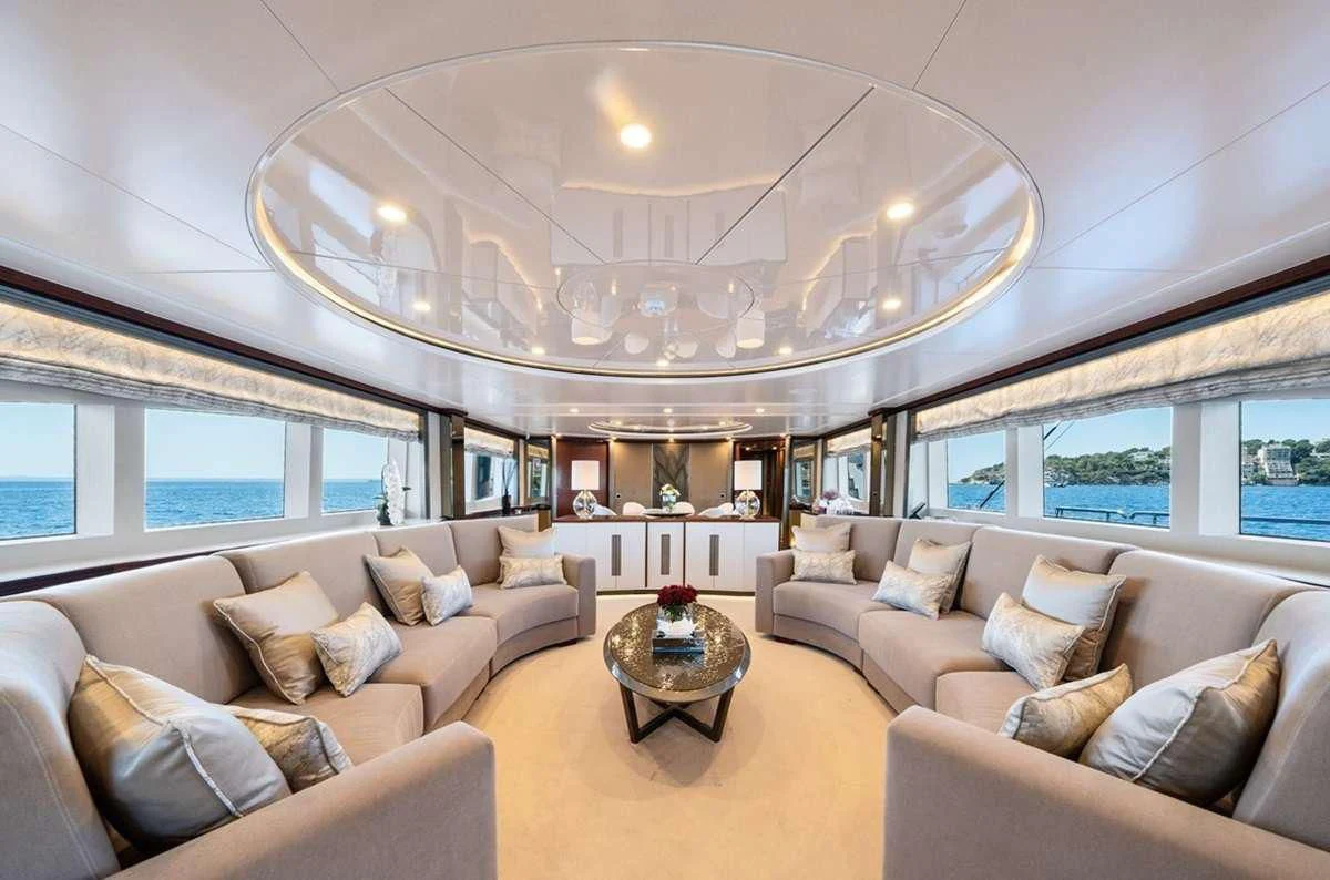 a living room with a large chandelier aboard TITIAN PEARL Yacht for Sale