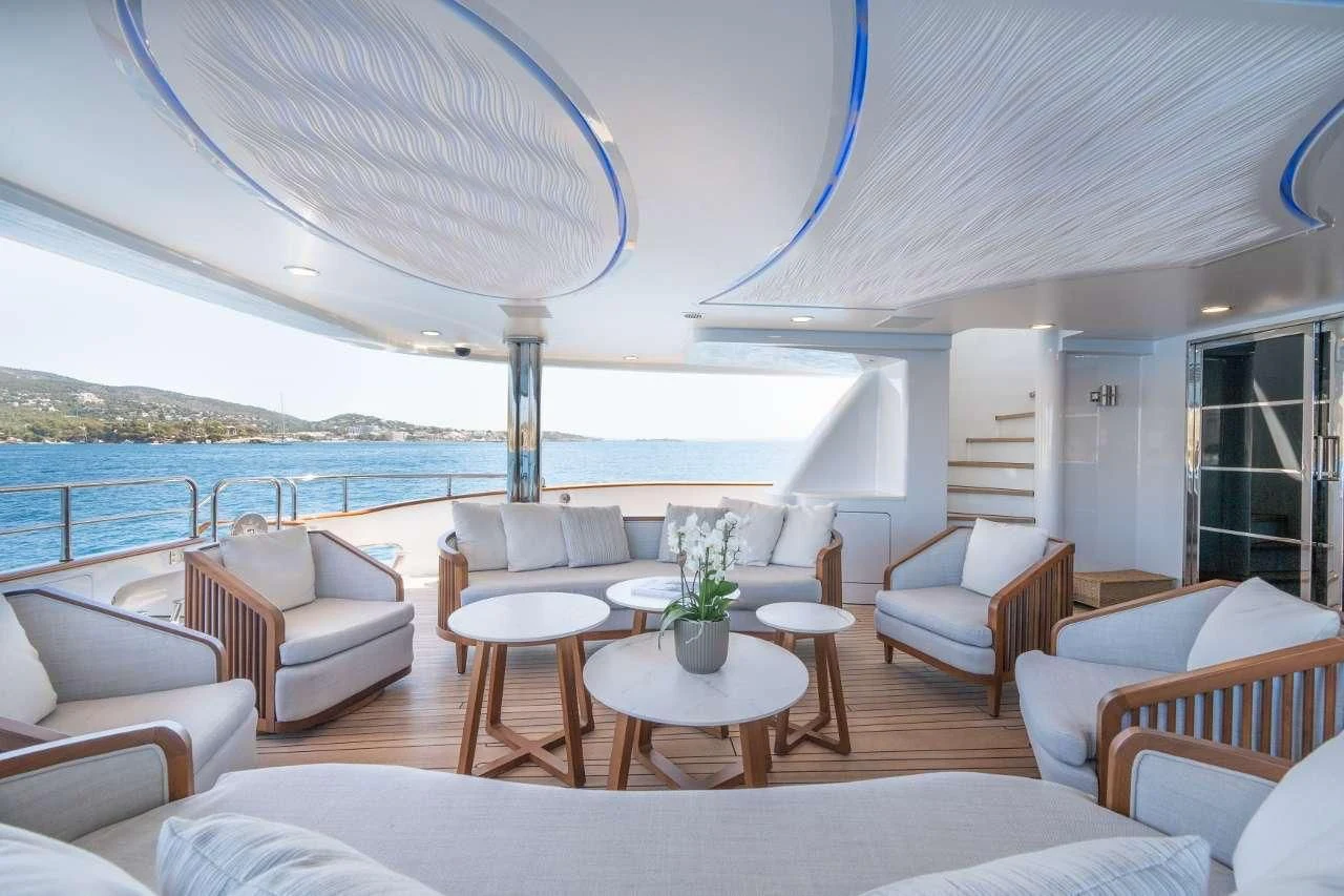 a large living room with a large balcony overlooking the ocean aboard TITIAN PEARL Yacht for Sale