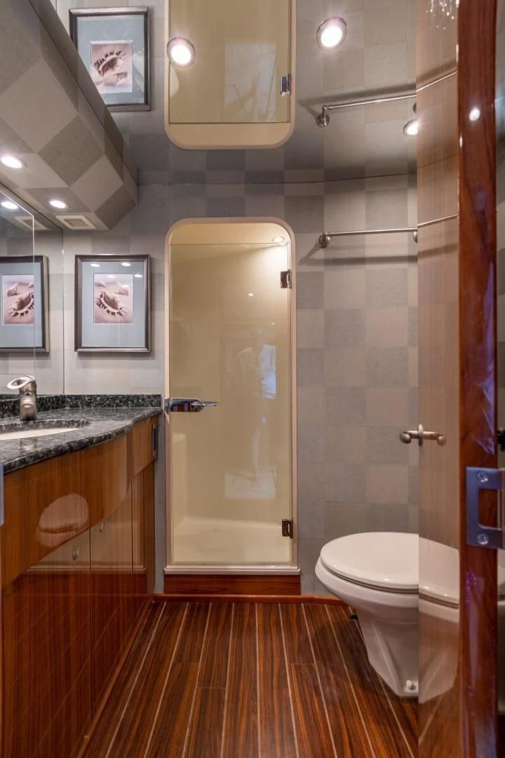 a bathroom with a glass shower door aboard HOME RUN Yacht for Sale