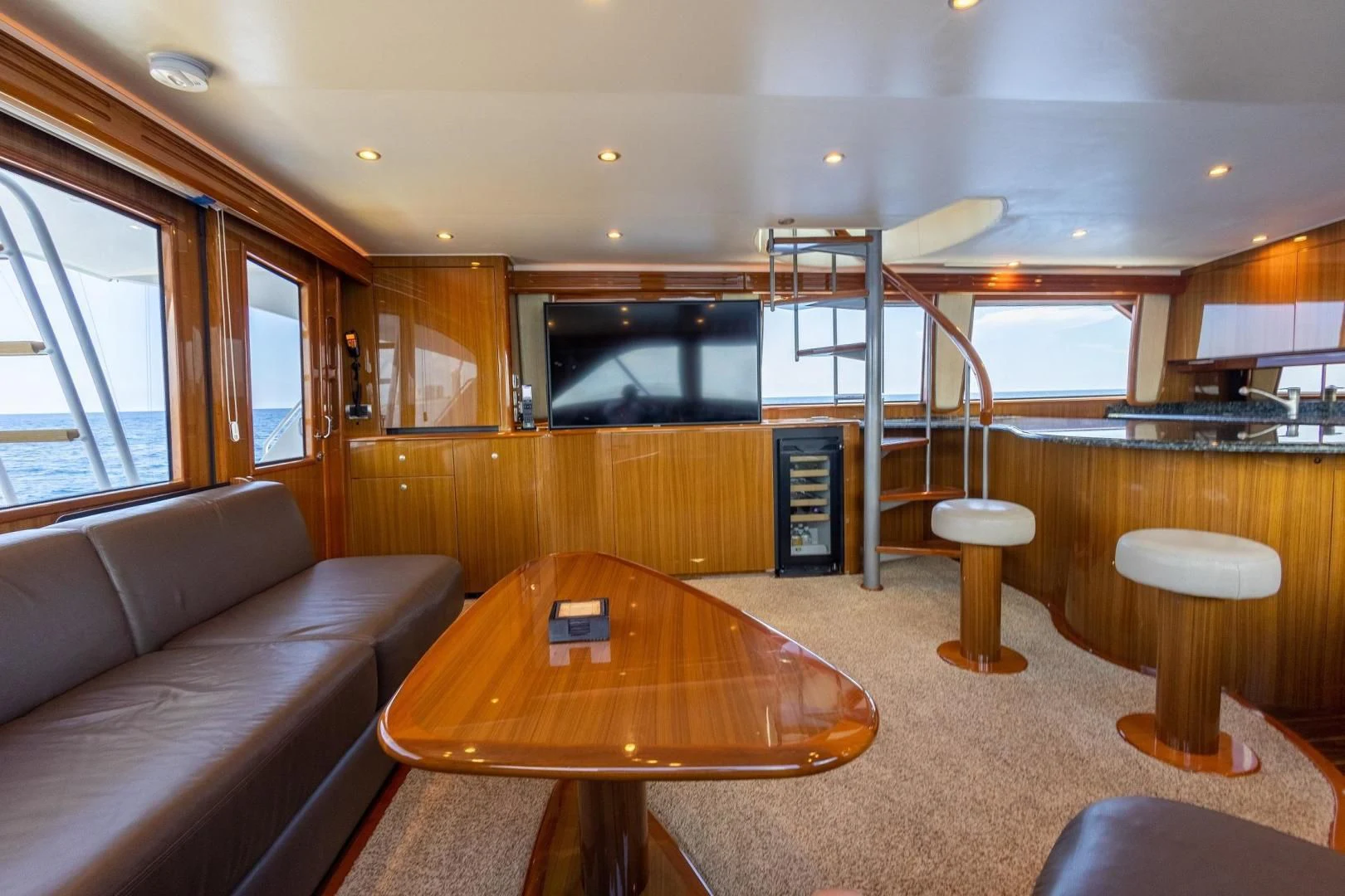 a living room with a table and stools aboard HOME RUN Yacht for Sale