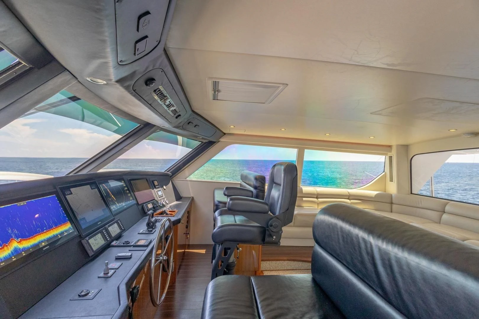 inside of a vehicle with many monitors and seats aboard HOME RUN Yacht for Sale