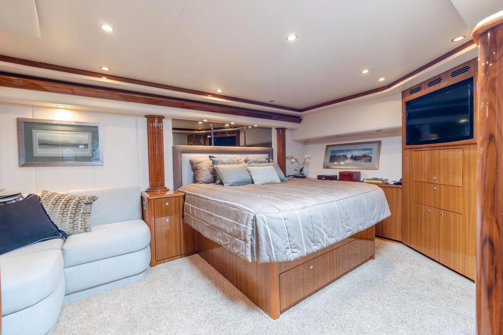 a bedroom with a bed and a couch aboard HOME RUN Yacht for Sale