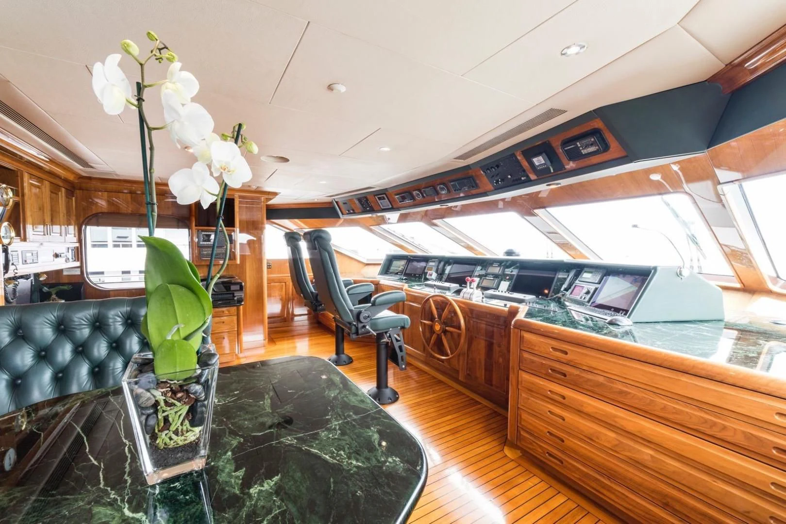 a room with a piano and flowers aboard POPEYE Yacht for Sale