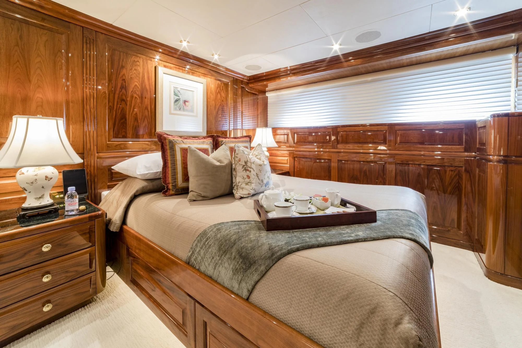 a bed with a table and a lamp in a room aboard POPEYE Yacht for Sale