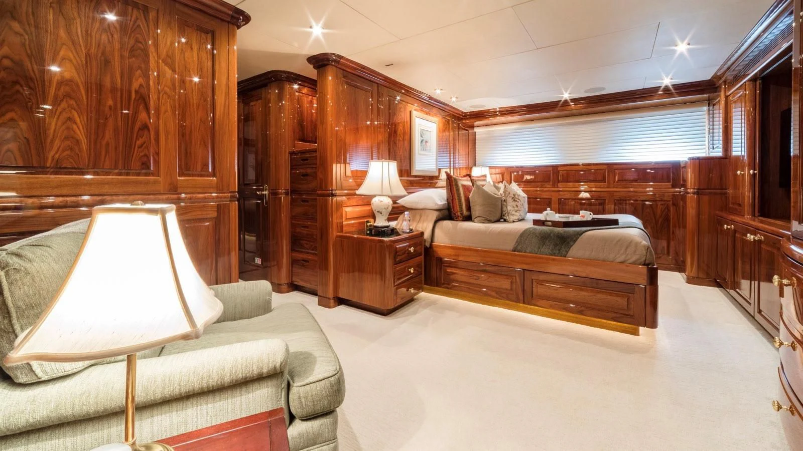a bedroom with a bed and a lamp aboard POPEYE Yacht for Sale