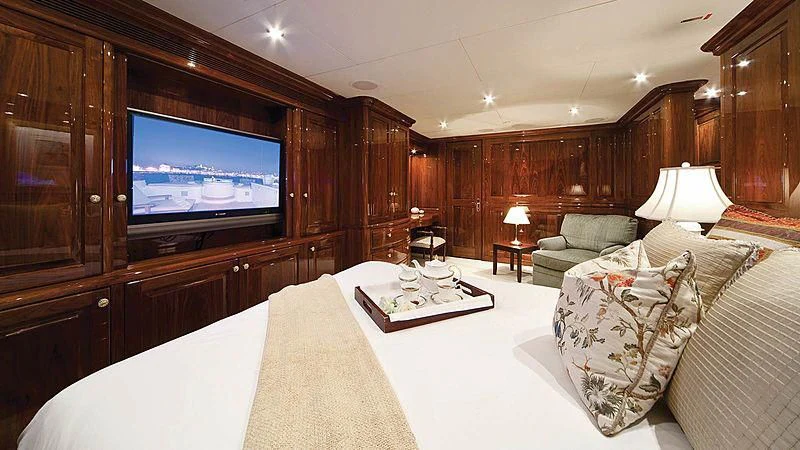 a hotel room with a tv and bed aboard POPEYE Yacht for Sale