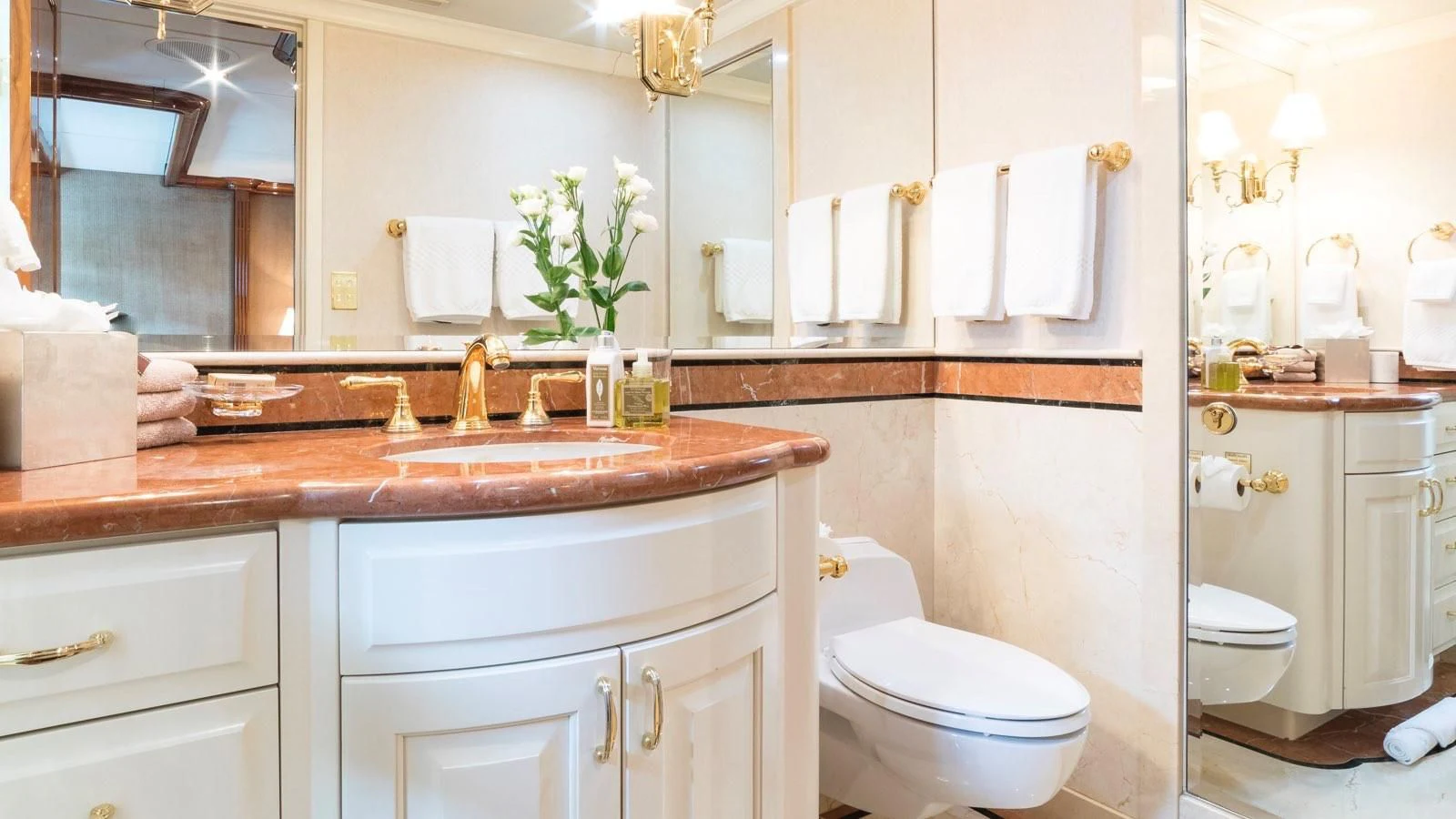 a bathroom with a sink toilet and a mirror aboard POPEYE Yacht for Sale