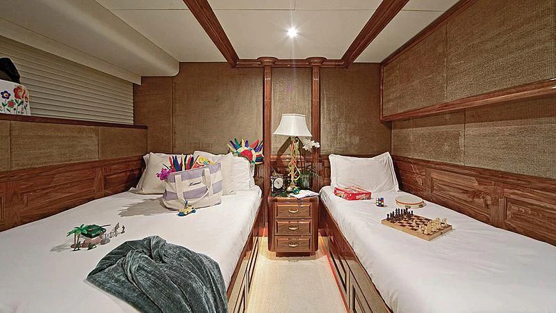 a room with a bed and a table aboard POPEYE Yacht for Sale
