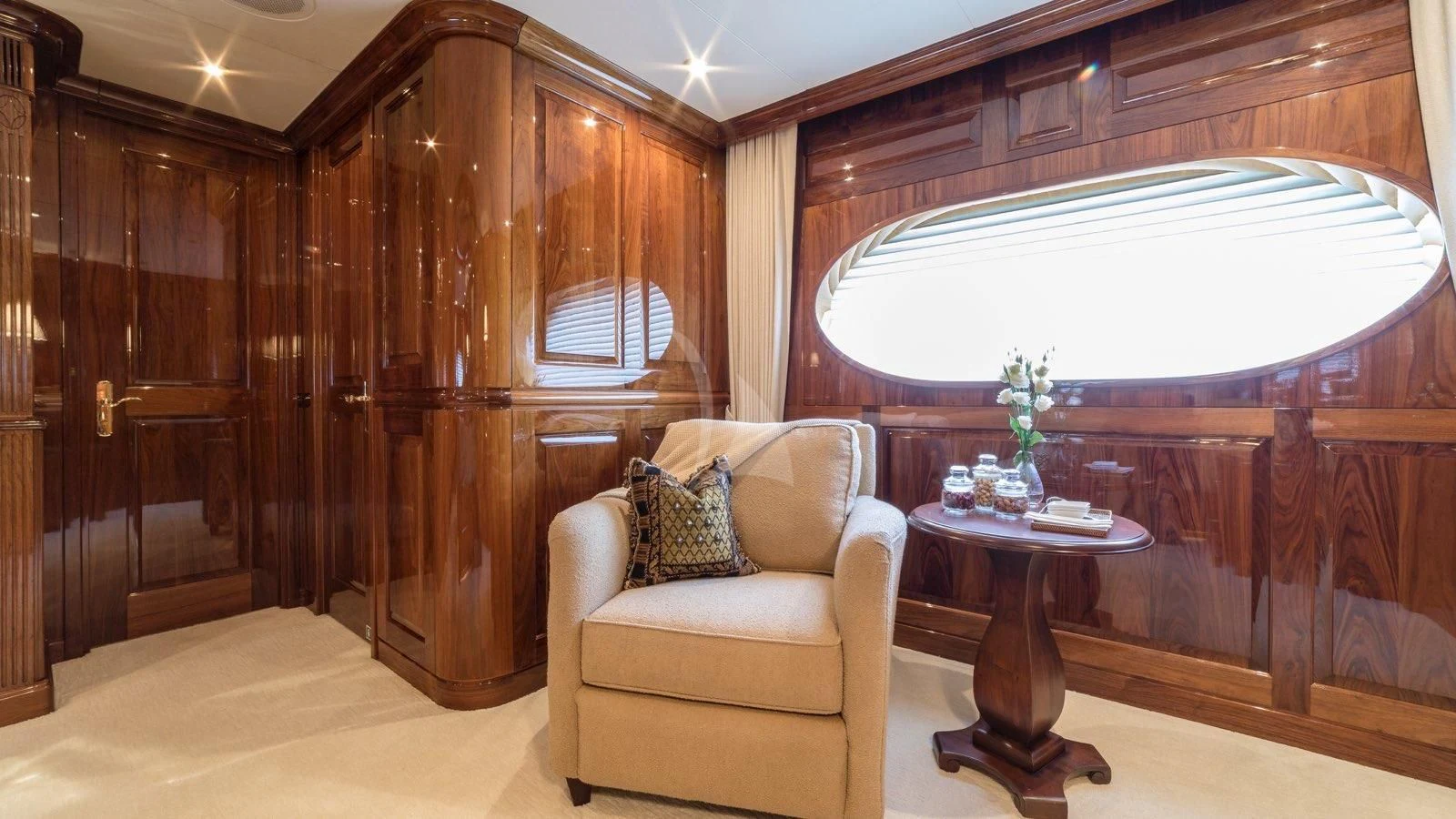 a room with a chair and a table and a window aboard POPEYE Yacht for Sale
