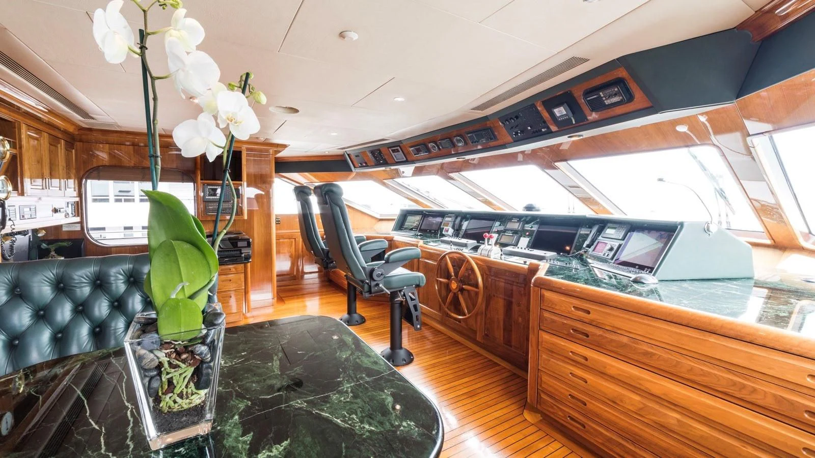 a room with a piano and a plant in it aboard POPEYE Yacht for Sale