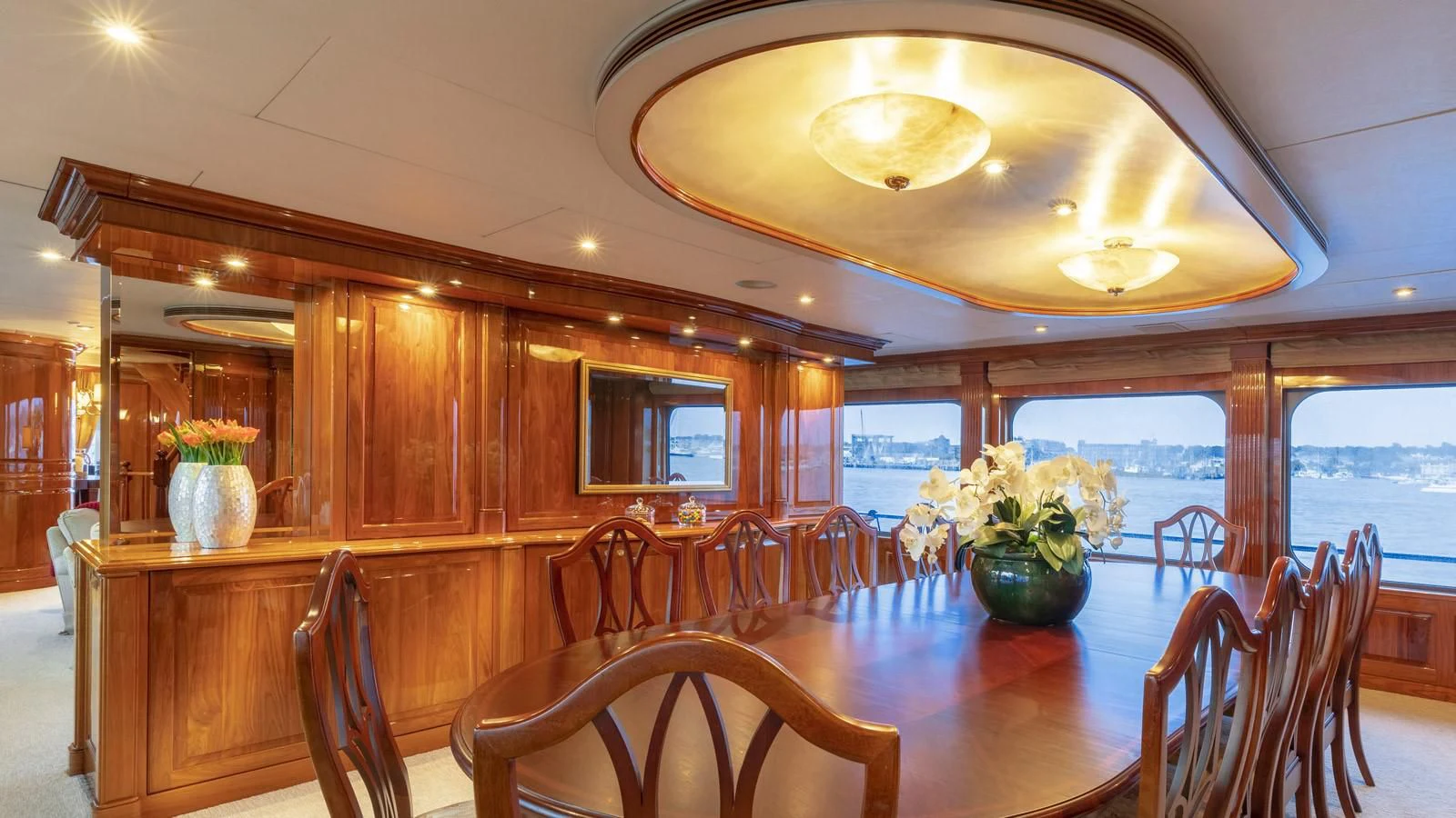 a wood dining room with a large window and wood cabinets aboard POPEYE Yacht for Sale