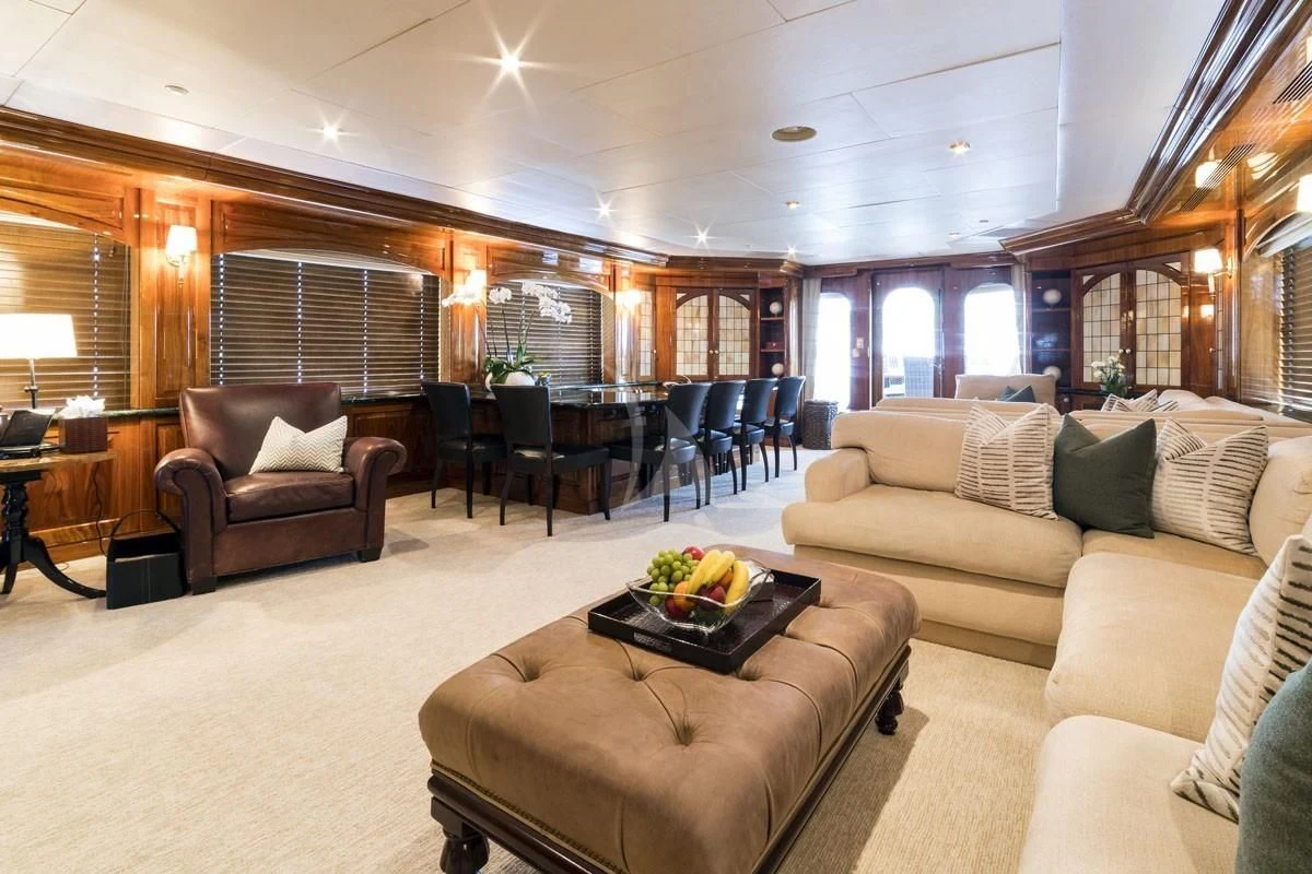 a living room with a couch and a coffee table aboard POPEYE Yacht for Sale