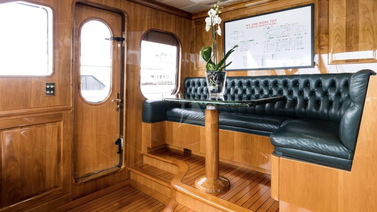 a black leather sofa in a room aboard POPEYE Yacht for Sale