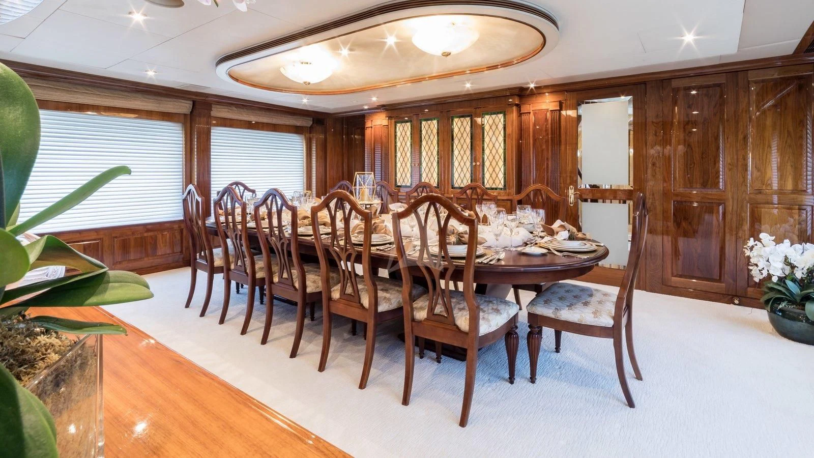 a dining room table and chairs aboard POPEYE Yacht for Sale