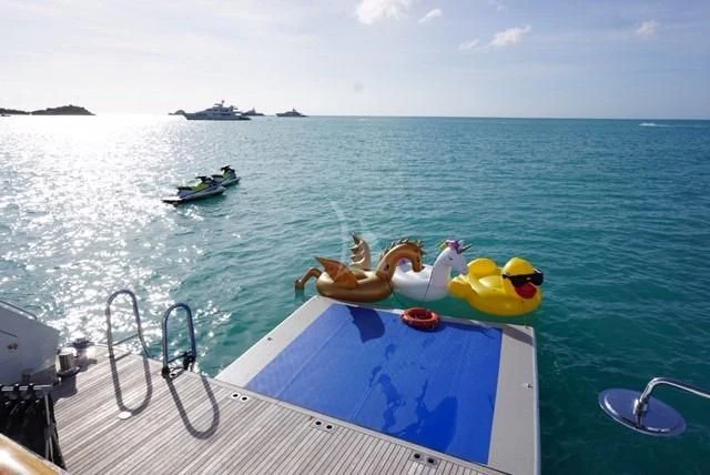 a person lying on a boat in the water aboard POPEYE Yacht for Sale