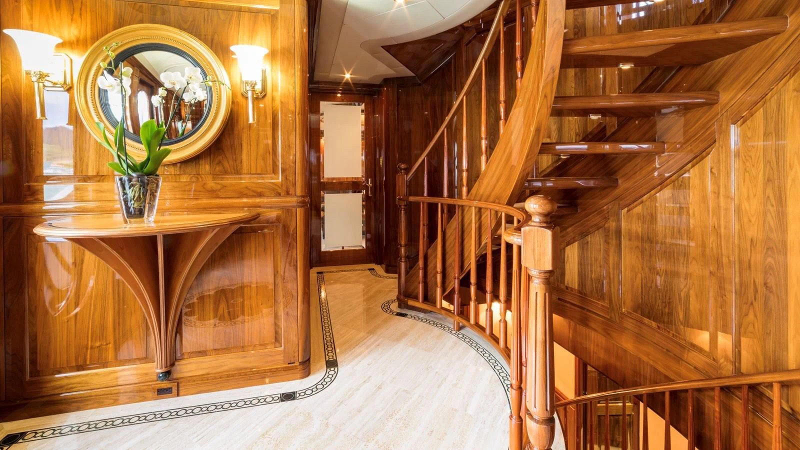 a wooden staircase with a mirror aboard POPEYE Yacht for Sale